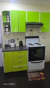 a kitchen with lime green cabinets and a stove at FAMILY CLICK HOMEs in Lilongwe +10 photos
