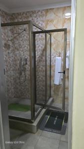 a shower with a glass door in a bathroom at FAMILY CLICK HOMEs in Lilongwe