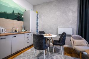 een keuken met een tafel en stoelen in een kamer bij Mountain goat Bjelašnica in Bjelašnica +46 foto's