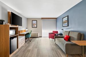 a living room with a couch and a tv at Red Lion Hotel & Conference Center Cheyenne in Cheyenne