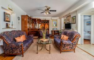 a living room with two couches and a table at Villa Mary by Villas Guide in Jadranovo