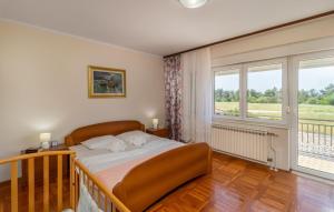 a bedroom with a bed and a large window at Villa Mary by Villas Guide in Jadranovo +42 photos
