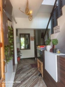 a hallway of a house with potted plants at Dreamy beach in Puducherry