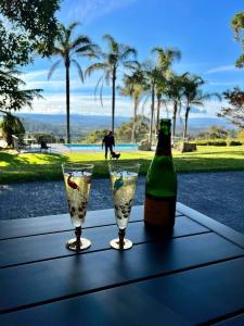 a bottle of wine and two glasses on a table at Yarra Valley Views in Lilydale
