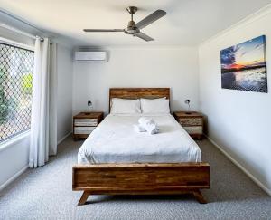a bedroom with a bed and a ceiling fan at The Ranch 4brm,3bth,AC,Pool in Glenella