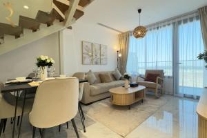 a living room with a couch and a table at Elegant 2BR - Rooftop Luxe Skyline Escape in Abu Dhabi +53 photos