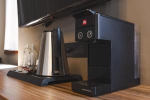 a coffee maker sitting on top of a table at 9 stanze - Boutique Rooms in Trieste