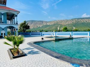 a swimming pool in front of a building at harvest haven in Alwar