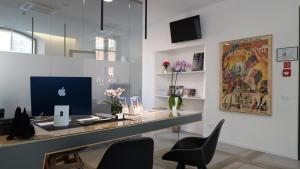 an office with an apple computer on a desk at Corte Novella Hotel & Residence in Brescia