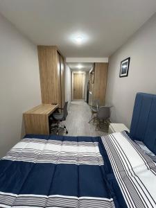 a bedroom with a bed and a desk and chairs at Spectacular apartment in the heart of Bogotá! in Bogotá