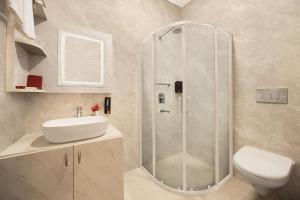 a bathroom with a shower and a sink and a toilet at WelcomHeritage Arka Resort & Spa, Rishikesh in Bijni +25 photos