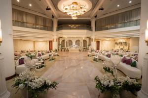 a large banquet hall with white chairs and tables at Holiday Inn Olaya by IHG in Riyadh +168 photos