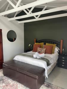a bedroom with a large bed with orange pillows at Seven in Secunda
