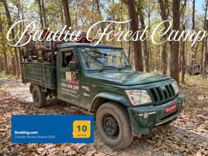 a green jeep truck parked in the woods at Bardia Forest Camp in Bardia