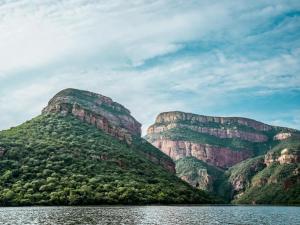 a view of a mountain from the water at AfriCamps Hoedspruit in Hoedspruit