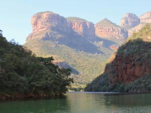 a view of a river with mountains in the background at AfriCamps Hoedspruit in Hoedspruit