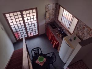 an overhead view of a kitchen with a table and a refrigerator at Serra da Capela in São José da Barra