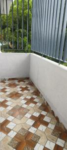a balcony with a wall and a tile floor at RK Lodging in Phaltan