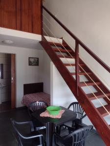 a room with a staircase and a table and chairs at Serra da Capela in São José da Barra +26 photos