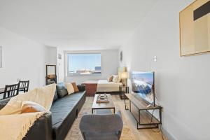 a living room with a couch and a bed at CozySuites Modern Studio Condo at Showboat #12 in Atlantic City +30 photos