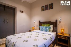 - une chambre avec un lit et deux lampes sur les tables dans l'établissement StayVista at Vintage Varanasi by the Ganges with Wi-Fi, Boards Games, à Varanasi