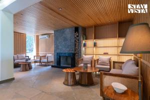 a living room with a couch and a fireplace at StayVista at Uno - The Himalayan Den with Jacuzzi in Barog