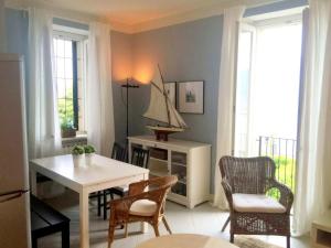 a living room with a table and a boat on the wall at Apartment in Ghiffa with Lake Maggiore Views in Ghiffa