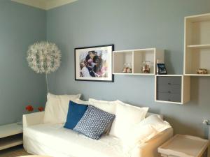 a living room with a white couch and blue walls at Apartment in Ghiffa with Lake Maggiore Views in Ghiffa