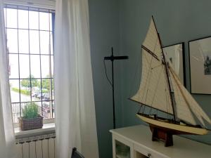 a model boat on a table in a room with a window at Apartment in Ghiffa with Lake Maggiore Views in Ghiffa