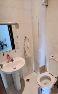 a bathroom with a toilet and a sink at Appartement Centre Ville - ATLAS 46 in Fès +29 photos