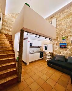 a living room with a staircase and a kitchen at Lourença Stays - Quinta Lourença in Vilar