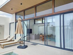 an open living room with a pool and a house at Samui Luxury villas -By Samui Rental Villas in Nathon Bay