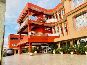 a red building with balconies on the side of it at Golden key hotel in Dawhwenya