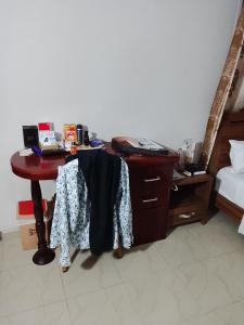 a desk in a room with a bed and a laptop at Golden key hotel in Dawhwenya