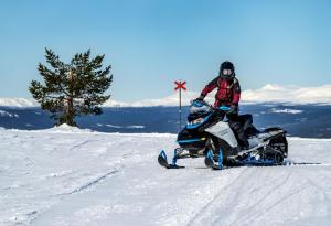 a person on a snowmobile in the snow at Idre Himmelfjäll Resort in Idre