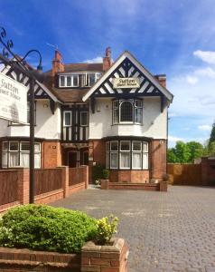 a building with a sign on the front of it at Sutton Guest House in Birmingham