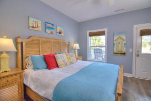 a bedroom with a bed with a wooden head board at Stairway to Havens - South in Myrtle Beach +42 photos