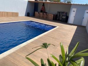 a swimming pool in front of a house at Espaço Carvalho in Itapecerica da Serra +8 photos