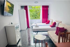 a living room with two beds and a couch at Cozy 2-Bed & Sofa-bed Studio - Pool Pets Wifi in Los Cristianos