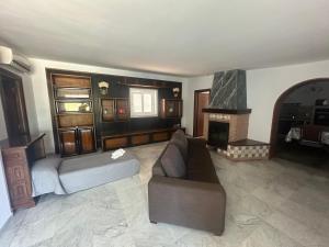 a living room with a couch and a fireplace at Villa Lelli 2 in Rome