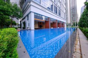 a swimming pool in front of a building at Luxe Spacious 2br Condo Klcc 600mbps Full Furnish in Kuala Lumpur