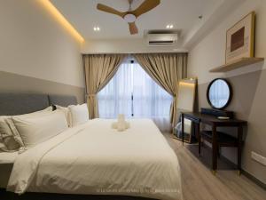 a bedroom with a bed and a desk and a window at La Gente X Agile Bukit Bintang Trx Pavilion Kl in Kuala Lumpur +29 photos