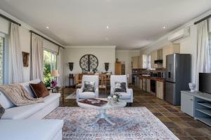 a living room with a white couch and a table at Bonne Chance Luxury Estate in Lynedoch