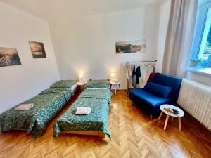 a room with three beds and a blue chair at Chalupa Veselí in Veselí nad Moravou +35 photos