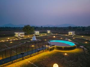 a large courtyard with a swimming pool and lights at Astrophile By Zuper in Wada