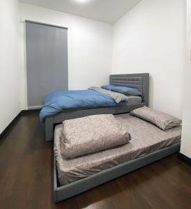 two beds in a room with two mattresses at La Gente Comfy Stay 2r2b Velocity - Kl City View in Kuala Lumpur +35 photos
