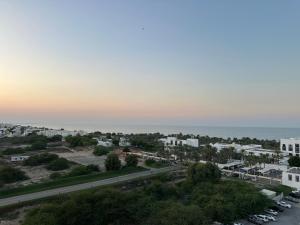 an aerial view of a city with the ocean at Pinnacle Row Seaview Elegance in Muscat