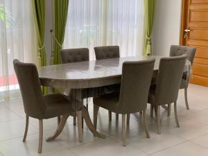 a dining room table with six chairs around it at Regus Jaffna in Jaffna