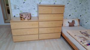 a bedroom with a chest of drawers and a bed at Haus am Schaumberg in Tholey