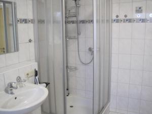 a bathroom with a shower and a sink at Haus am Schaumberg in Tholey +17 photos